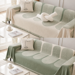 Two sides of cream and sage reversible sofa cover