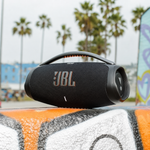 JBL Boombox 3 black portable speaker in an outdoor lifestyle setting
