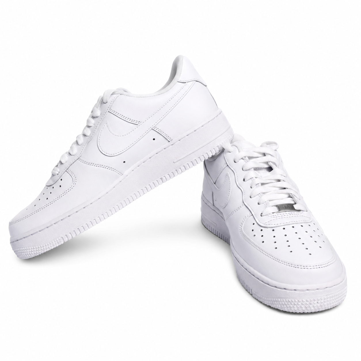 White low-top sneakers on a white background